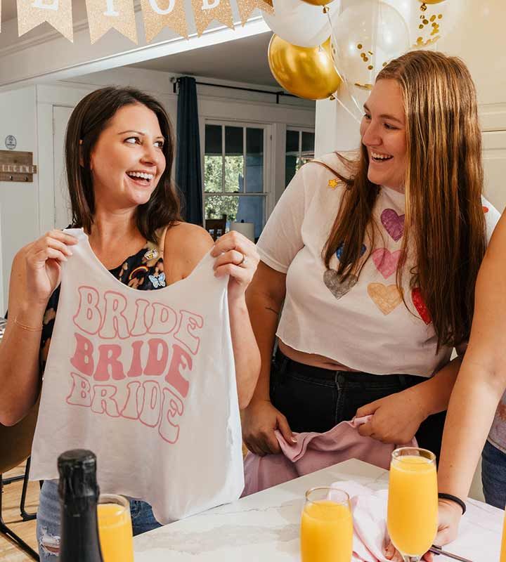 Friends at a bachelorette party creating craft clothes