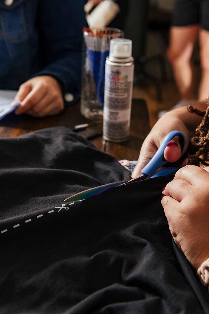 Woman cutting out tshirt design with scissors