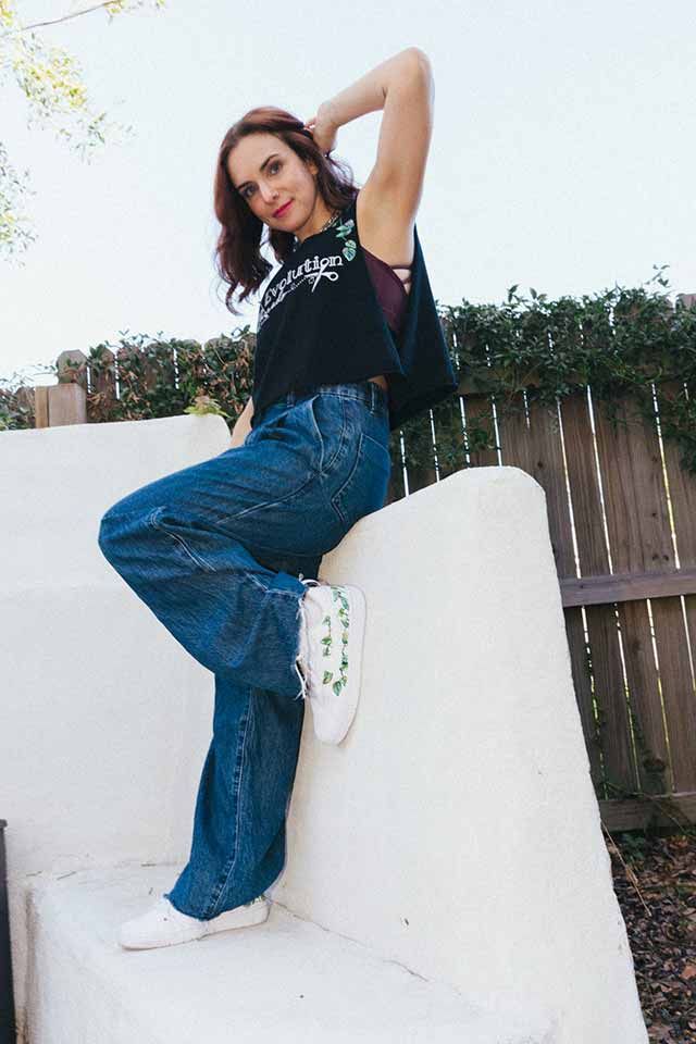 Lyndsey posing on a white wall