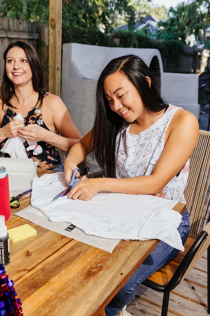 Girls working on craft fashion shirts on game day