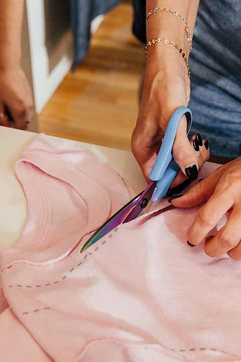 Cutting a tshirt with scissors for custom design at bachelorette party